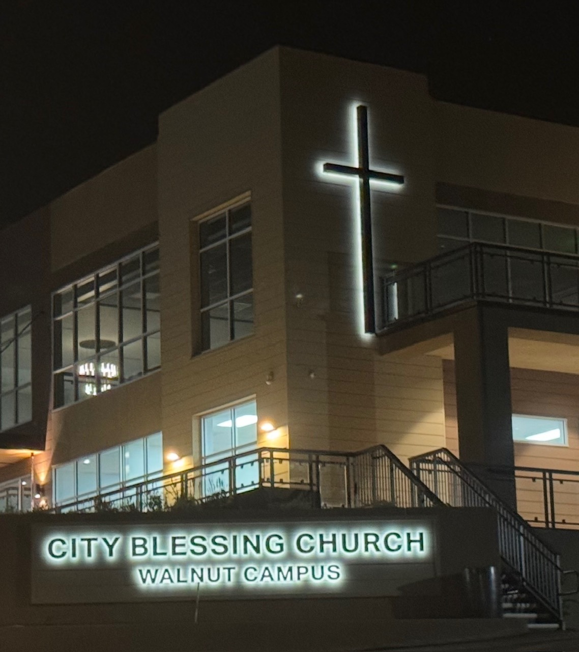 City Blessing Church Walnut Campus monument sign with backlit LED letters and a glowing halo-lit cross at night