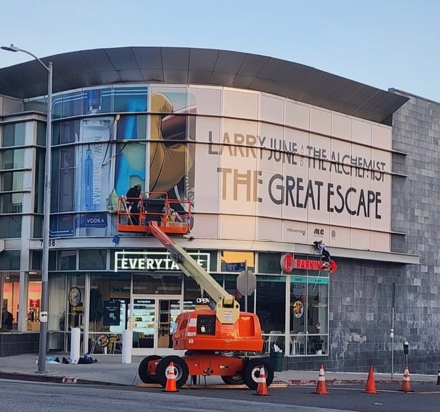 Large-format building wrap for Larry June & The Alchemist – The Great Escape installation