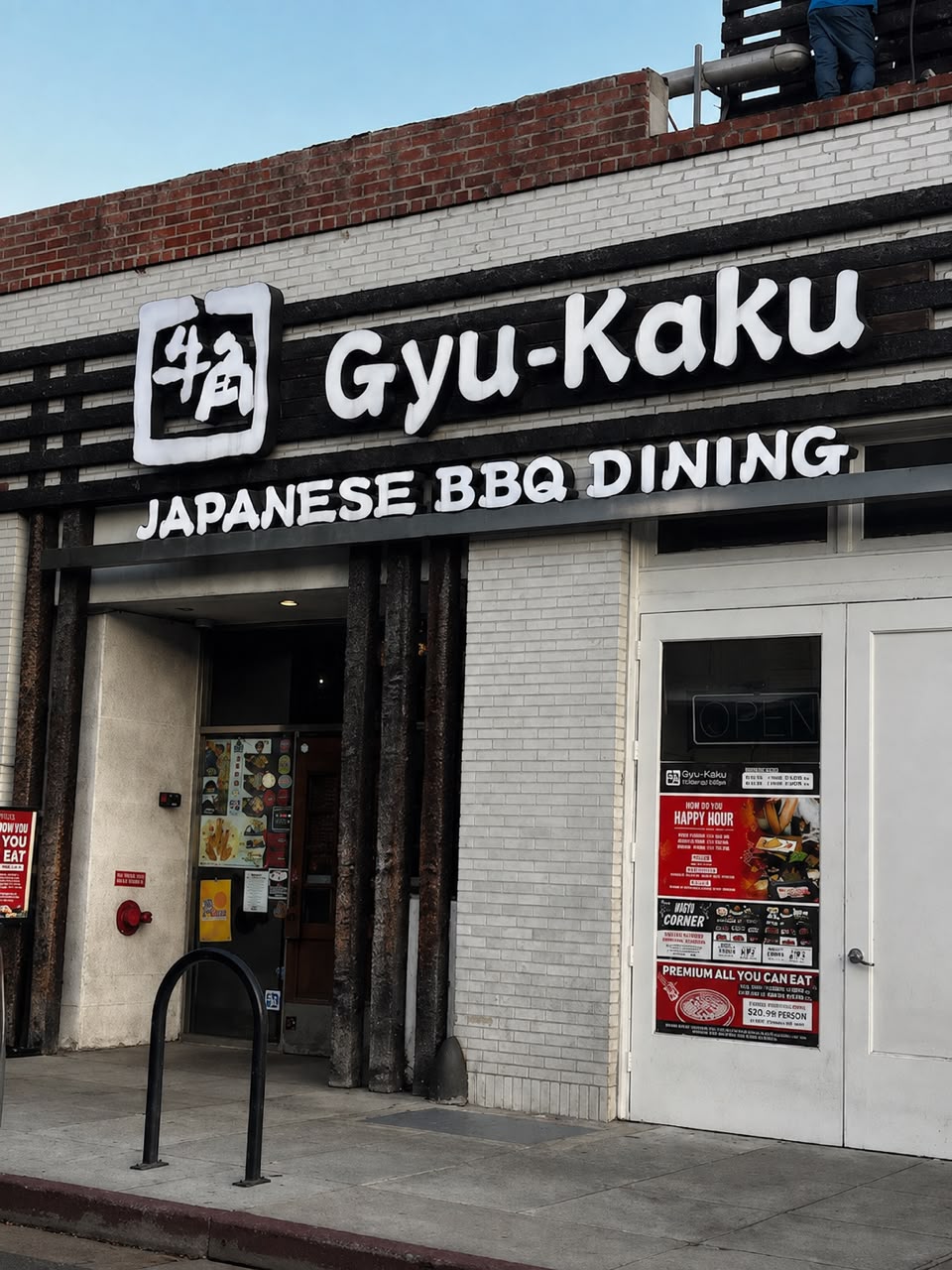 Gyu-Kaku Japanese BBQ Dining storefront with white dimensional letters on a black fascia