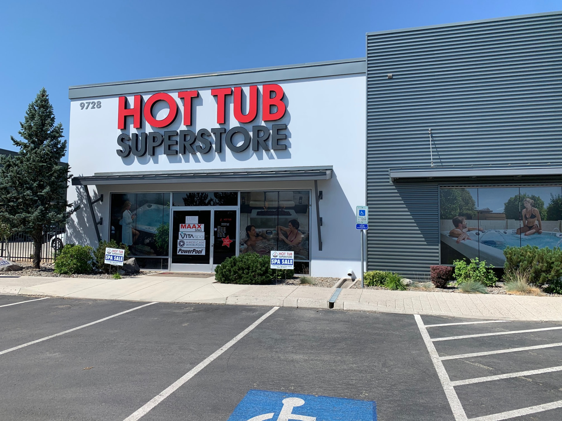 Hot Tub Superstore building with large red and gray dimensional letters on a white facade