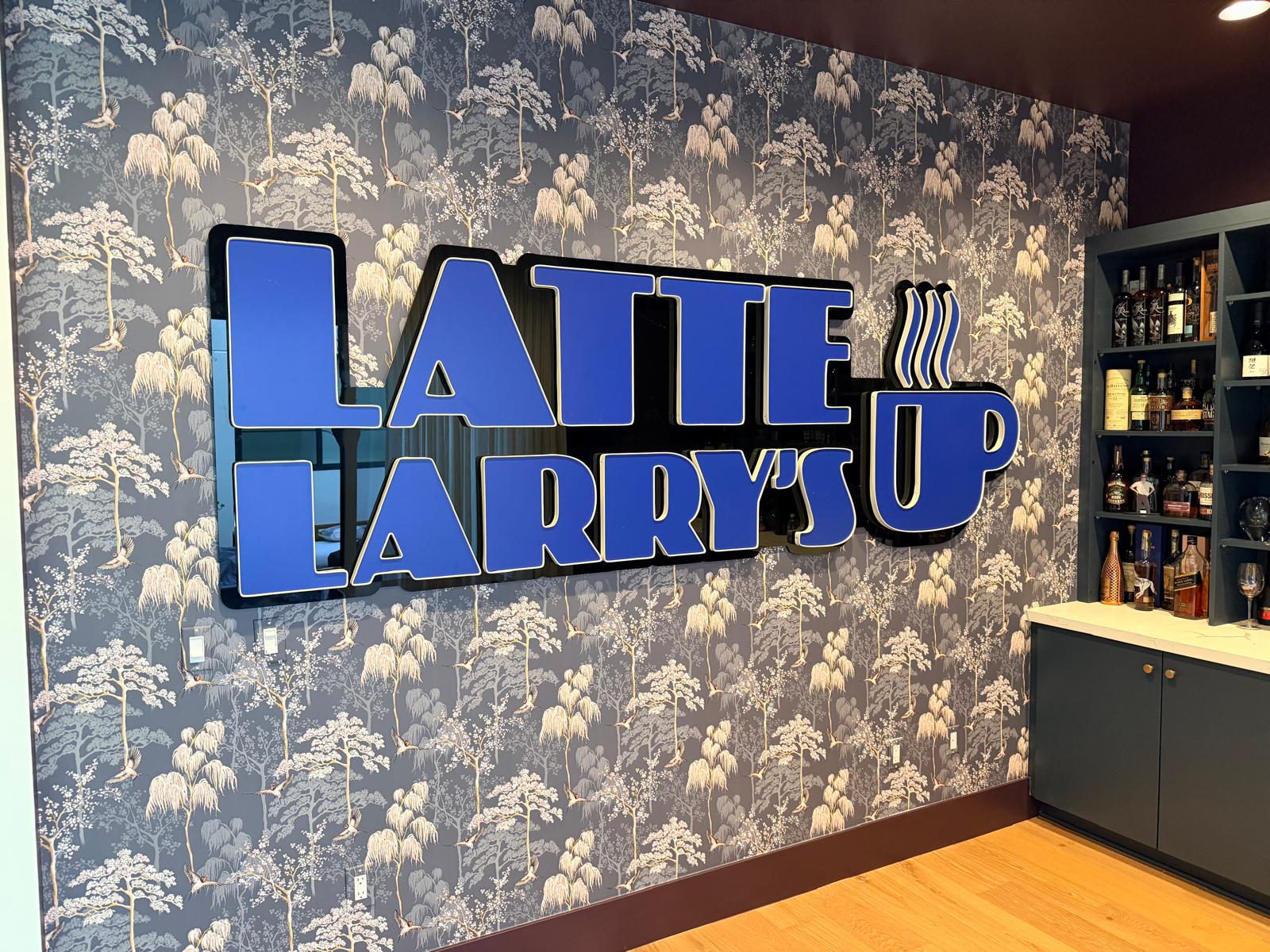 Large blue Latte Larry's dimensional wall sign installed inside the venue